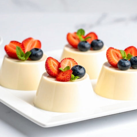 4 Vanilla Panna Cotta's set on a plate in a high end kitchen, made using Special Ingredients Beef Gelatine Powder